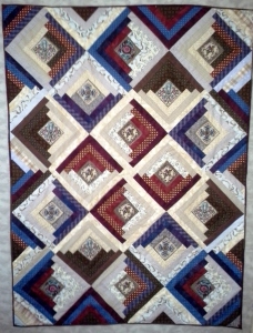 Front of the log cabin charity quilt, using a pinwheel arrangement set on point.